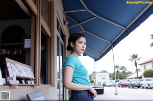 A woman in a blue shirt is holding a sheer white panties.