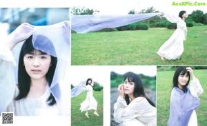 A woman in a white dress holding an umbrella.