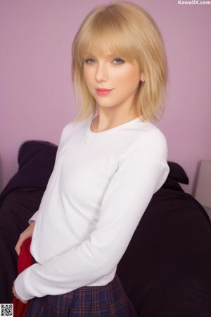 A woman in a blue bra and panties posing on a couch.