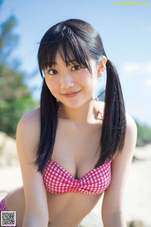 A woman sitting on a bench in a white towel.