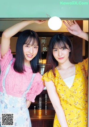 A couple of women standing on top of a set of stairs.