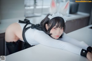 A couple of women in bunny ears are kissing each other.