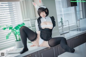 A couple of women in bunny ears are kissing each other.