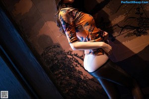 A woman sitting on a table with a brush in her hand.