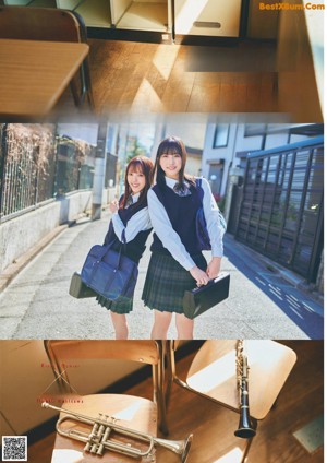 A couple of young women standing next to each other in front of a blackboard.