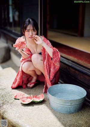 A woman in a blue dress posing for a picture.