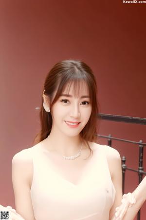 A woman in a pink dress posing for a picture.