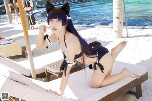 A woman in a black and white bikini with cat ears.