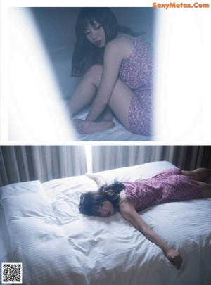 A woman sitting on a bed looking out a window.