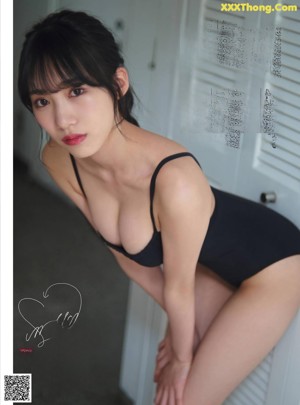 A woman in a white dress posing for a magazine.