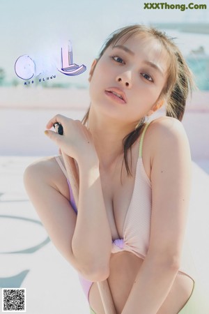 A woman in a nude bodysuit posing for a picture.