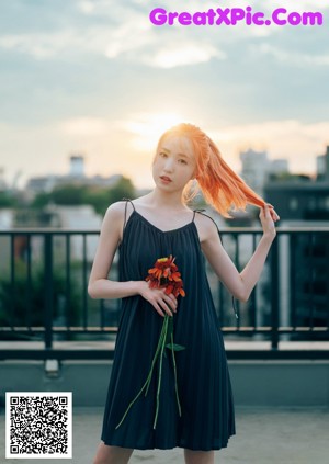 A woman holding a bunch of flowers in her hand.